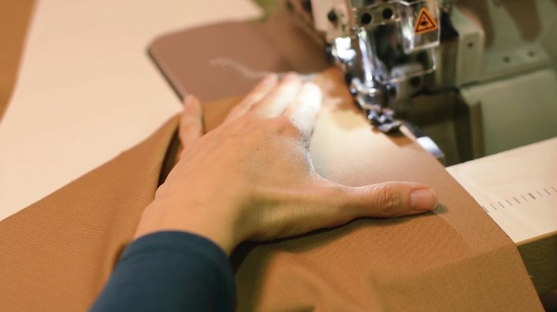 Manufacturing process that involves cutting pieces of fabric to a specific shape and then sewing them together to form a finished product.